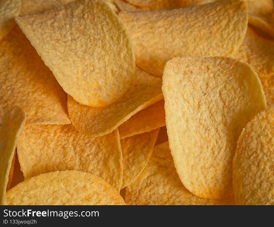 Potato chips close-up in direct sunlight - top view. High quality photo