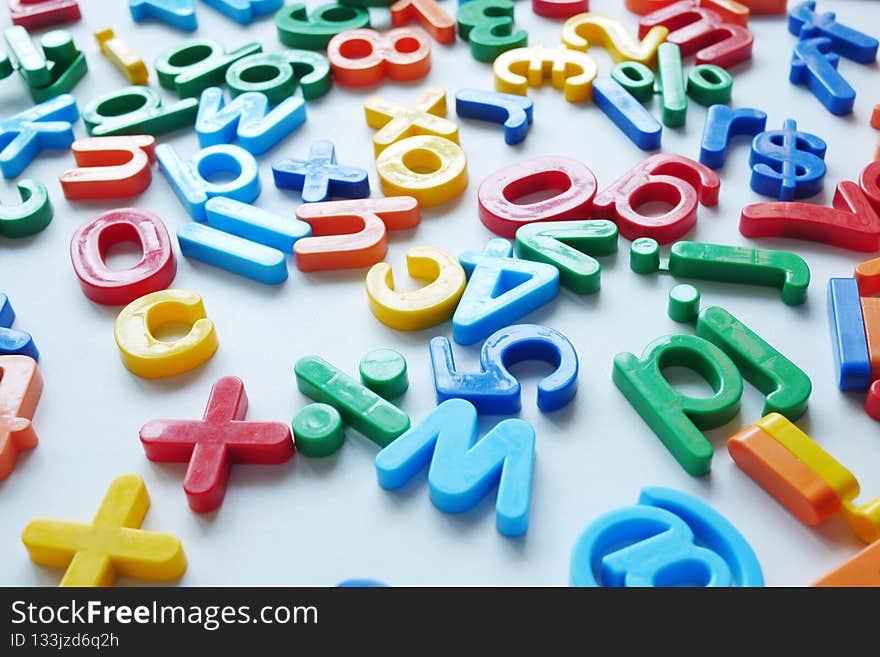 colorful plastic letters on white background, close up .