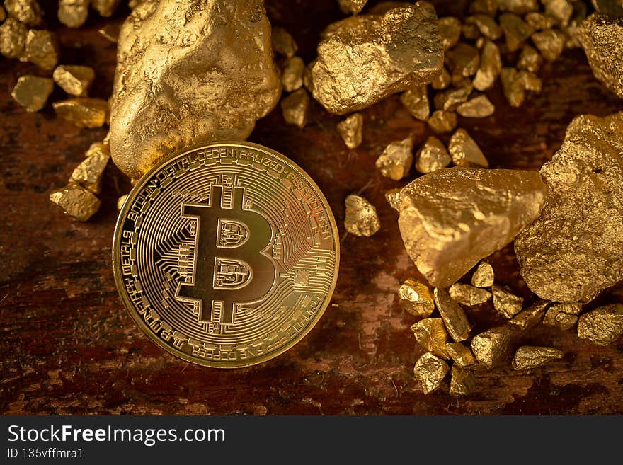 Gold bitcoin physical Bitcoin-Cryptocurrency and Gold nugget grains. Business concept