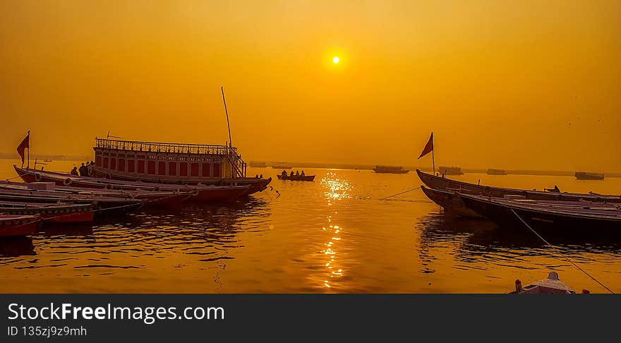 Varanasi is the holiest and most fascinating places in India and arguably the best way to experience Varanasi is to take a early morning boat ride down the Ganges.The early morning sun hung large and low in the sky. Slowly, it rose, shining brightly, casting a dewy glow over the holy river and the ghats. The sun shone a bright yellowy orange, it hung big and low in the sky. Varanasi is the holiest and most fascinating places in India and arguably the best way to experience Varanasi is to take a early morning boat ride down the Ganges.The early morning sun hung large and low in the sky. Slowly, it rose, shining brightly, casting a dewy glow over the holy river and the ghats. The sun shone a bright yellowy orange, it hung big and low in the sky.