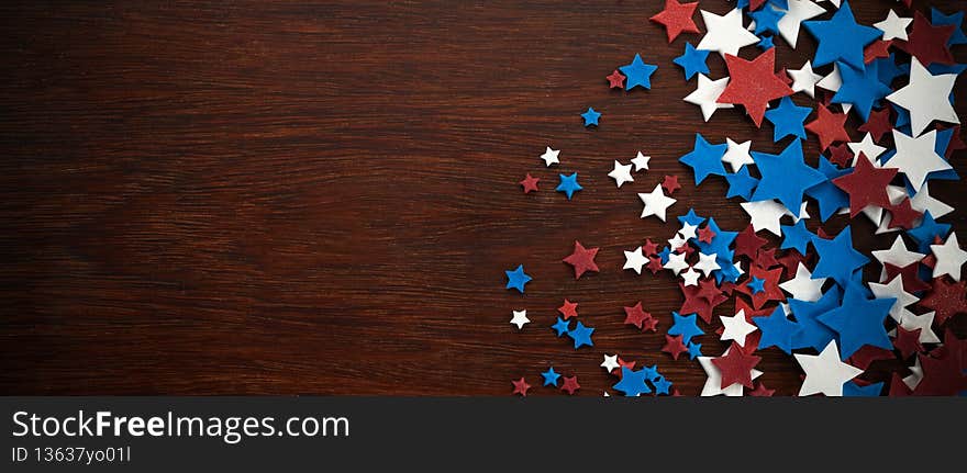 4th of July American Independence Day stars decorations on wooden background. Flat lay, top view.