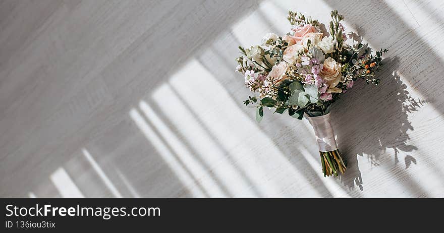 Wedding bouquet of peonies flowers on the floor of the newlyweds.