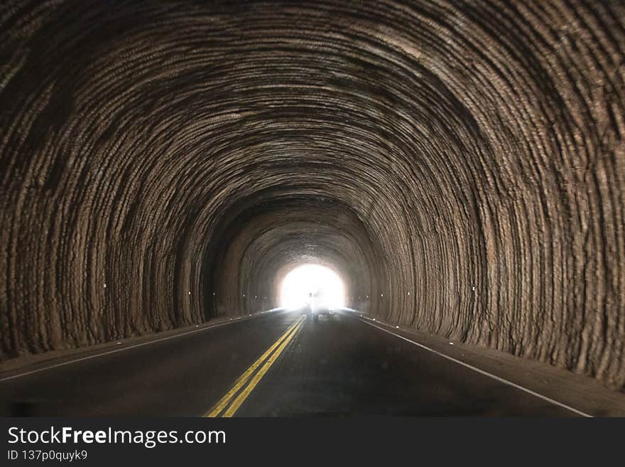 A picture of a Light at the end of the tunnel with a road