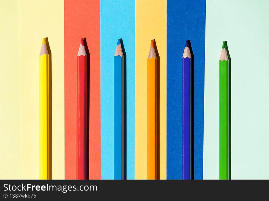 Color pencils on colored background. Back to school, arrangement concept.