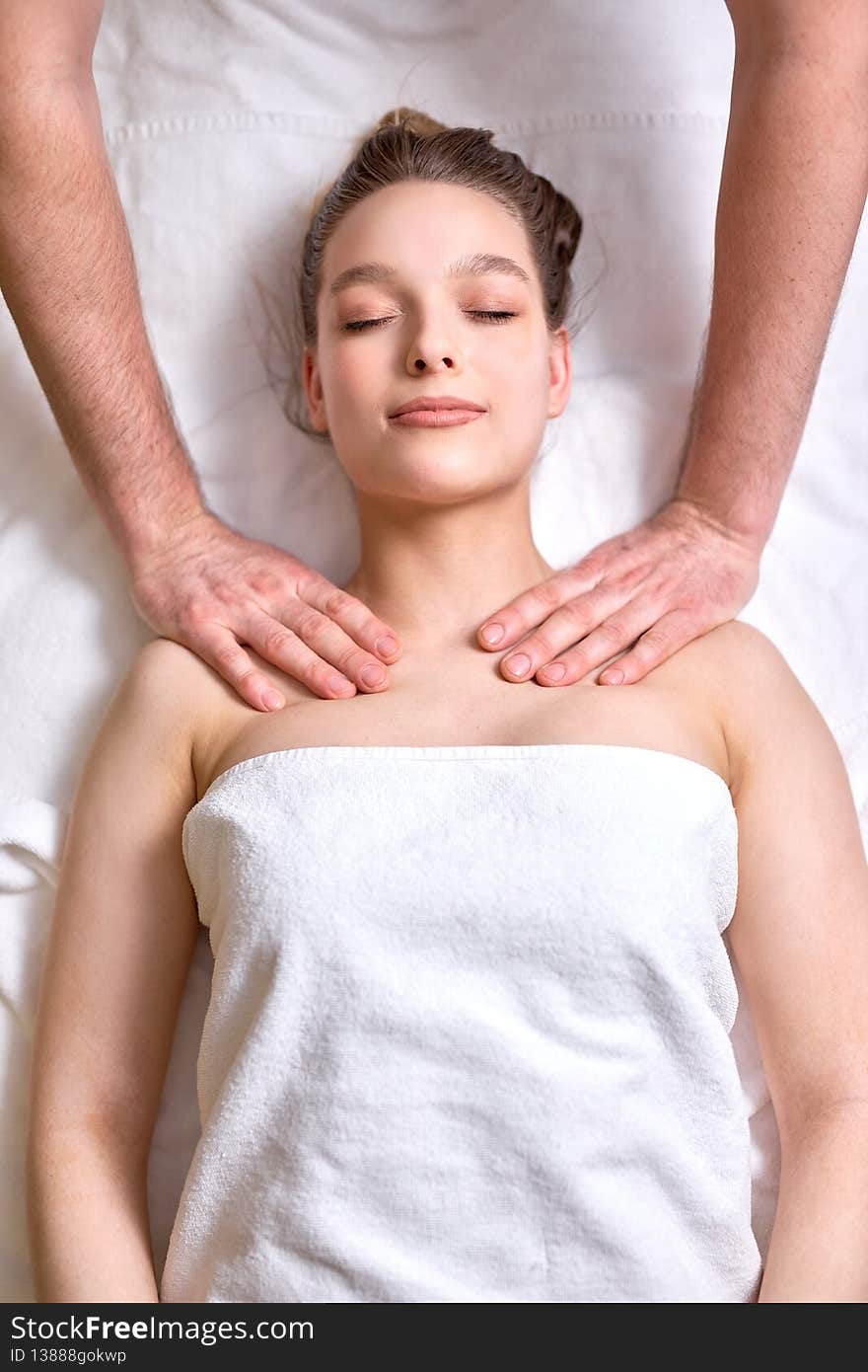 Relaxing Massage. Top view Female Receiving Shoulders And Neck Massage At Spa Salon, Female Lying With Eyes Closed, Enjoying Spa Procedures By Professional