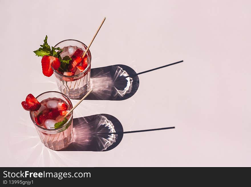 Strawberry mint soda in high contrast on plain pink background.