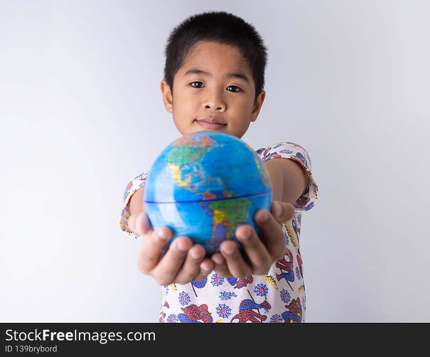Boy holding a globe stand out in front Show the power of the new generation to continue to develop our world