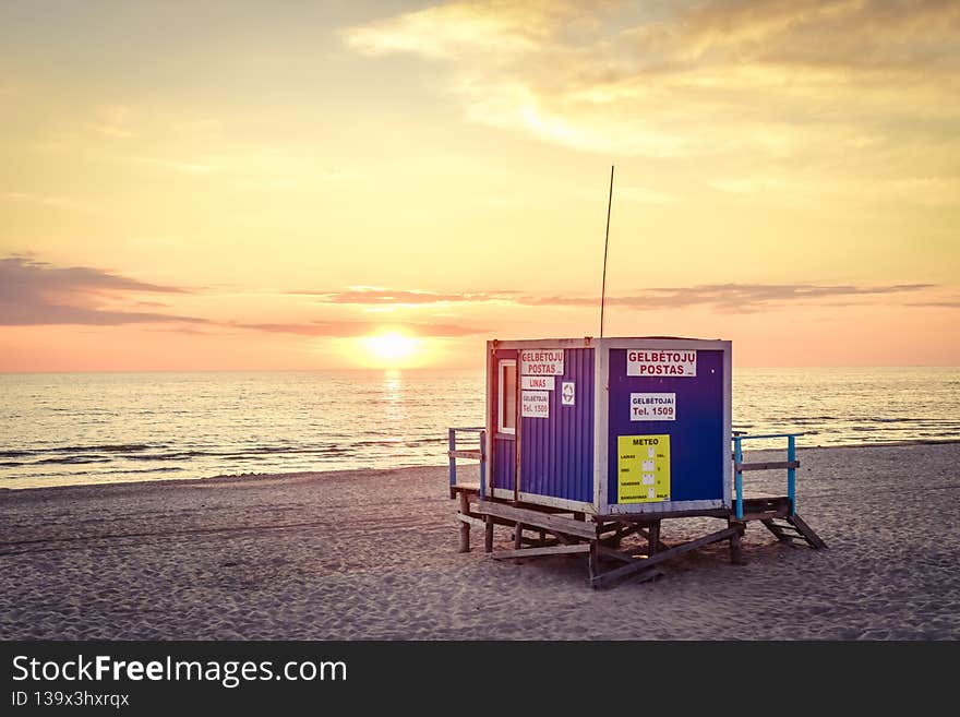 Dramatic evening on Palanga beach with beautiful sunset panorama and lifeguard watch tower. Lithuania summer holiday destination