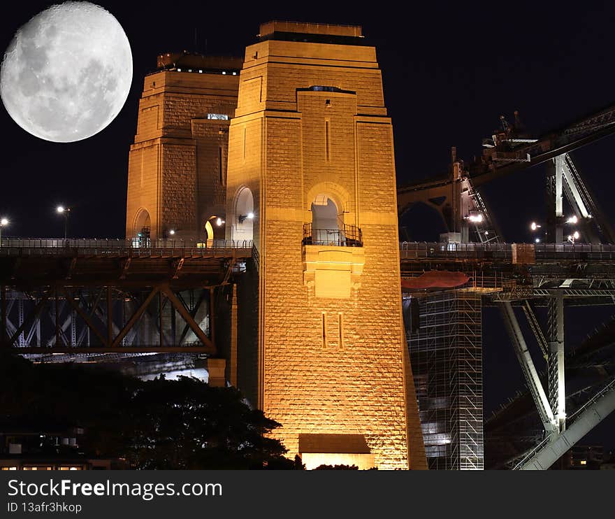Sydney harbour bridge illuminated by the moon and circular quay with vibrant colourful of the moon and lights at midnight in NSW Australia large moon. Sydney harbour bridge illuminated by the moon and circular quay with vibrant colourful of the moon and lights at midnight in NSW Australia large moon