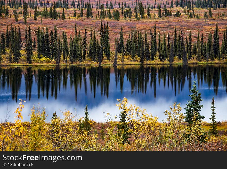 dramatic landscape of mountain peaks and mountain ranges inside Denali National Park during autumn season. dramatic landscape of mountain peaks and mountain ranges inside Denali National Park during autumn season.