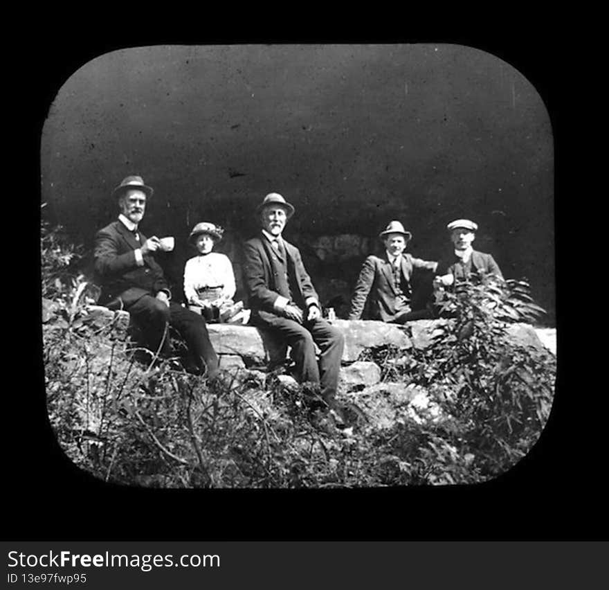 Group portrait of members of Royal Australian Historical Society sitting on rock ledge, taken during excursion to King&#x27;s Cave, Linden. Frank Walker on left, holding teacup.

This image is part of a collection entitled ‘Blue Mountains Excursions&#x27;, which is available to view on the Royal Australian Historical Society&#x27;s Historypin Channel. Access the collection at the following link: 

http://www.historypin.com/channels/view/id/48441/#|collections/view/id/3230/title/Blue Mountains Excursions

Please feel free to comment on this or any of the other images in the collection. If you have more accurate information regarding the location and/or date of the image, we would love to hear from you!. Group portrait of members of Royal Australian Historical Society sitting on rock ledge, taken during excursion to King&#x27;s Cave, Linden. Frank Walker on left, holding teacup.

This image is part of a collection entitled ‘Blue Mountains Excursions&#x27;, which is available to view on the Royal Australian Historical Society&#x27;s Historypin Channel. Access the collection at the following link: 

http://www.historypin.com/channels/view/id/48441/#|collections/view/id/3230/title/Blue Mountains Excursions

Please feel free to comment on this or any of the other images in the collection. If you have more accurate information regarding the location and/or date of the image, we would love to hear from you!