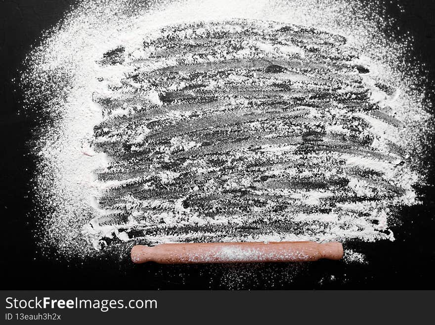 Pasta or bread cooking ingredients on black kitchen table. Top view with space for your text