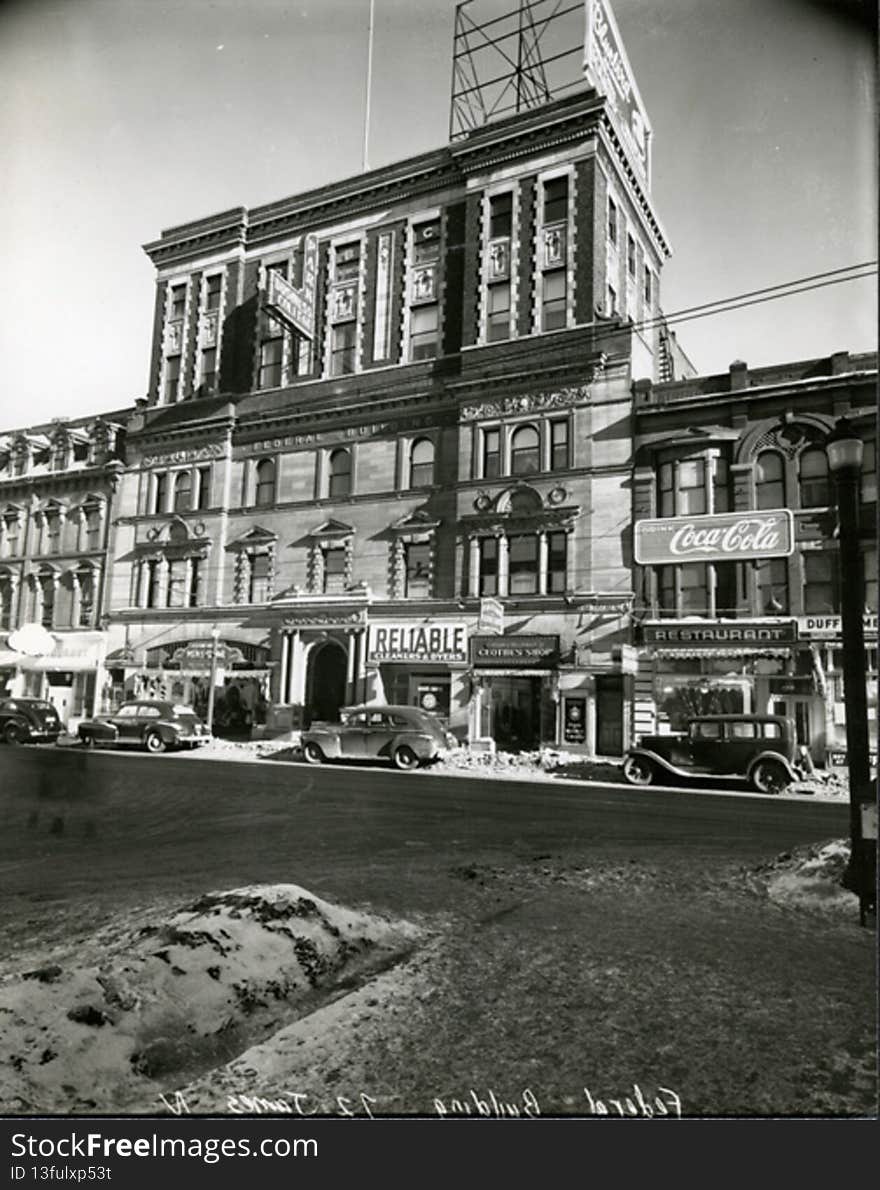 In 1898 the building was dramatically transformed into an entirely â€˜newâ€™ office building. Now five bays wide it was topped with elaborate side towers It later became the site of the Park Business College. The next renovation added two stories of brick so that the entire building is now a hodge podge of styles.

037-32022191131909. In 1898 the building was dramatically transformed into an entirely â€˜newâ€™ office building. Now five bays wide it was topped with elaborate side towers It later became the site of the Park Business College. The next renovation added two stories of brick so that the entire building is now a hodge podge of styles.

037-32022191131909