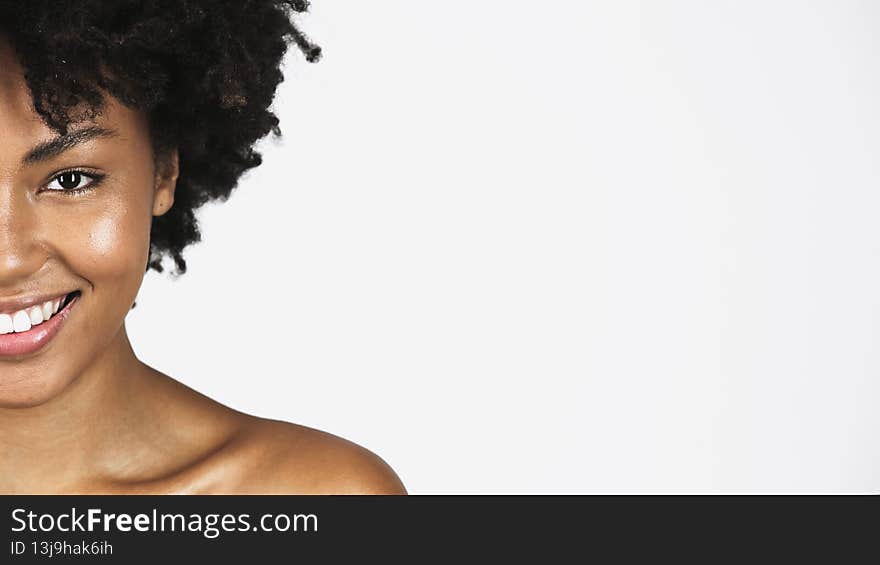 Cropped view of african american woman with clean skin smiling isolated on grey,stock image