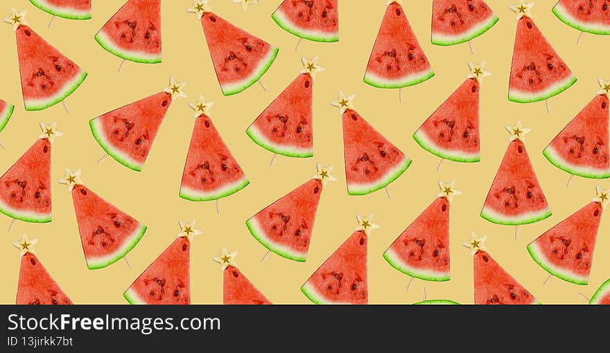 Watermelon background. Watermelon slices on a stick with a star from an apple top view. Fruit pattern. Banner. Christmas tree made of food. Summer Christmas.