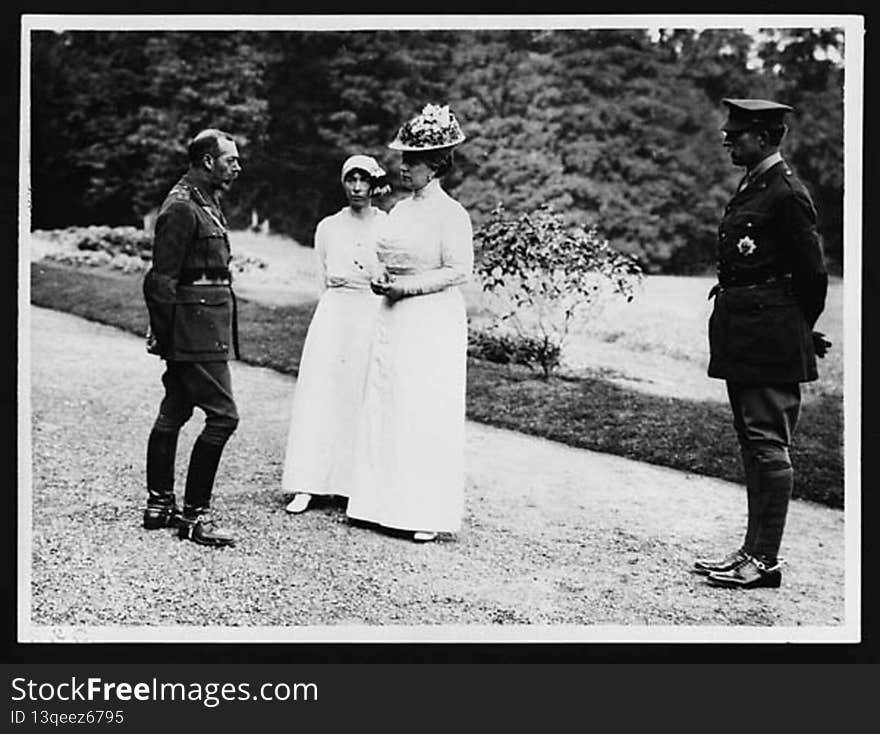 From left to right: King George V, Queen Elizabeth of Belgium, Queen Mary and King Albert I of Belgium. They are standing on a gravel path or driveway. Directly behind them a lawn slopes towards a row of trees. Both women are dressed in white and wearing hats. Queen Mary&#x27;s hat is adorned with flowers. 

During World War I royal families played an important ambassadorial role, forging and sustaining good relations between nations.

[Original reads: &#x27;ON THE BRITISH WESTERN FRONT IN FRANCE - Two King&#x27;s and two Queens [sic].&#x27;]

digital.nls.uk/74546724. From left to right: King George V, Queen Elizabeth of Belgium, Queen Mary and King Albert I of Belgium. They are standing on a gravel path or driveway. Directly behind them a lawn slopes towards a row of trees. Both women are dressed in white and wearing hats. Queen Mary&#x27;s hat is adorned with flowers. 

During World War I royal families played an important ambassadorial role, forging and sustaining good relations between nations.

[Original reads: &#x27;ON THE BRITISH WESTERN FRONT IN FRANCE - Two King&#x27;s and two Queens [sic].&#x27;]

digital.nls.uk/74546724