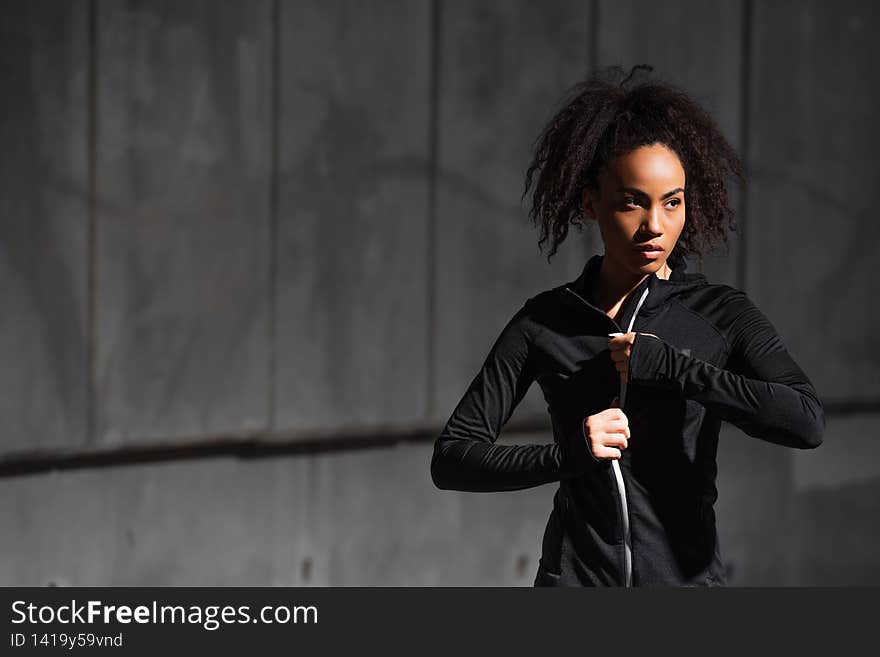 African american sportswoman wearing sports jacket outdoors,stock image