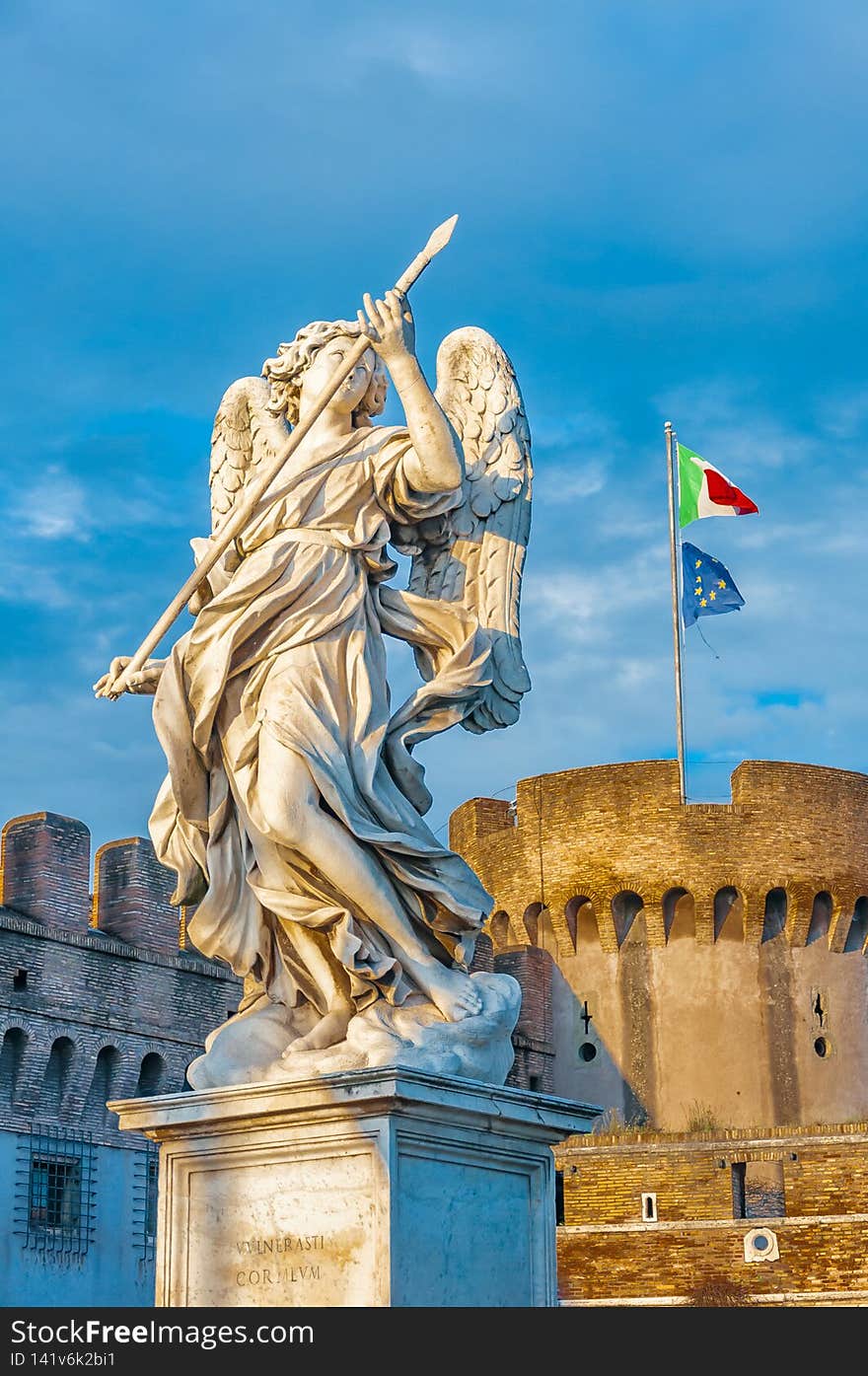 Statue of an angel standing on the bridge leading to the Castle Sant`Angelo, Rome.