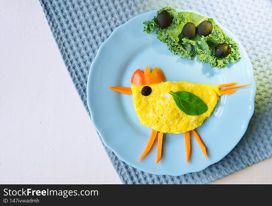 Funny dish for Kids. Omelette with vegetables in shape of chicken. Food art. Restaurant menu. Creative breakfast.