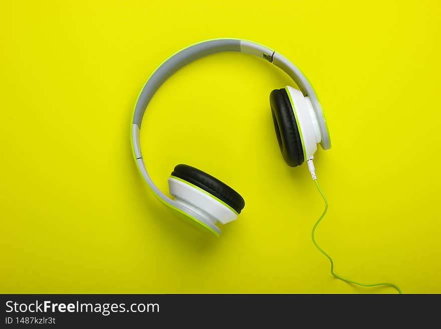 Stylish wireless stereo headphones on blue pastel background. Music lover. Gadgets. Top view