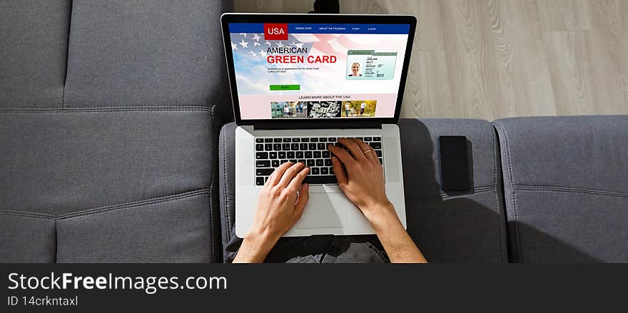man with laptop with United States Permanent Resident Card website