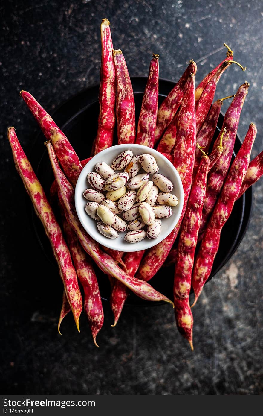 Cranberry beans in bowl. Beans pods. Top view