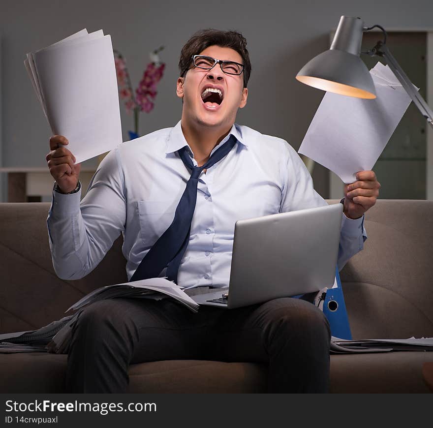 The businessman workaholic working late at home