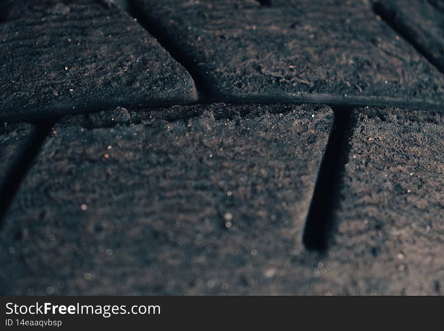 Macro photograph of a sports car tire tread. Selective focus