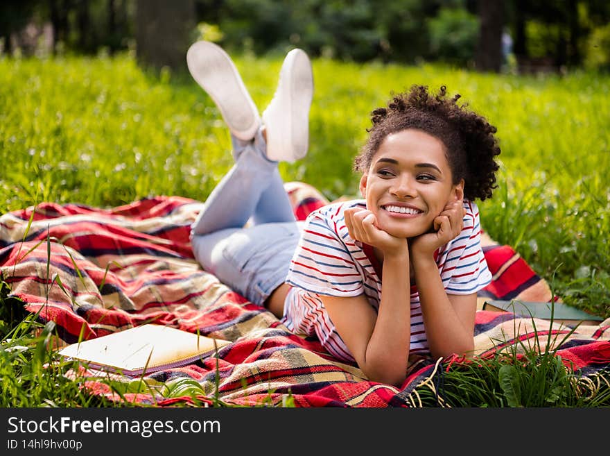 Full length body size photo female student laying on blanket in park smiling dreamy chilling on weekend.