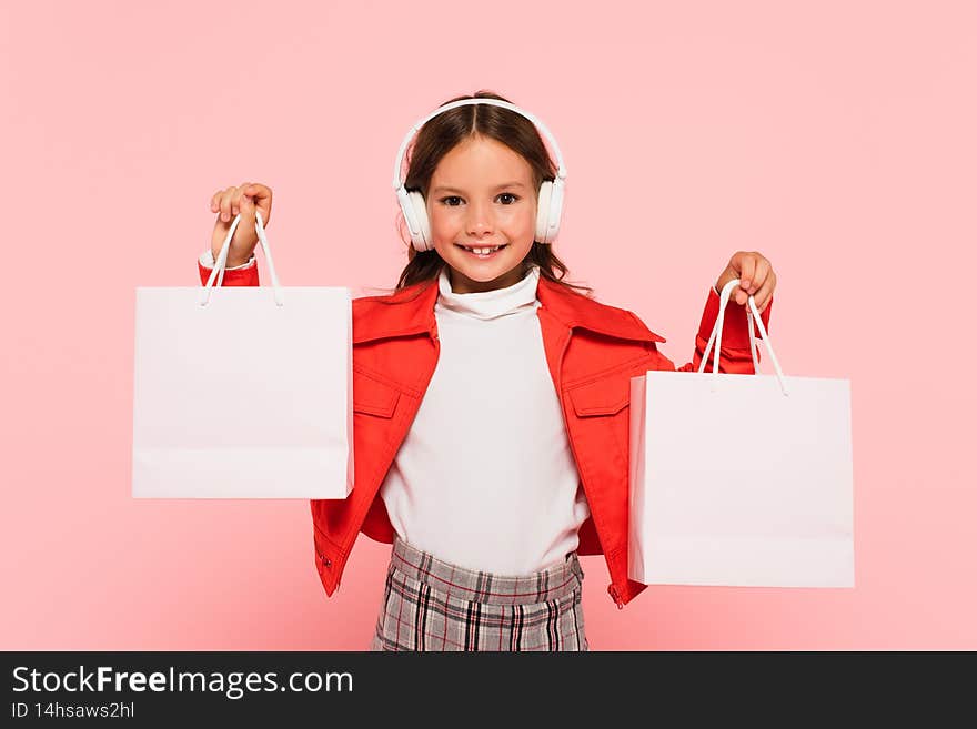 joyful child in headphones and orange