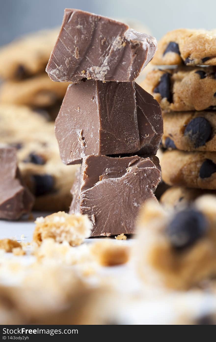 broken wheat flour cookies and large pieces of sweet chocolate together, cookies with chocolate pieces inside, closeup food for desserts crumbled cookies