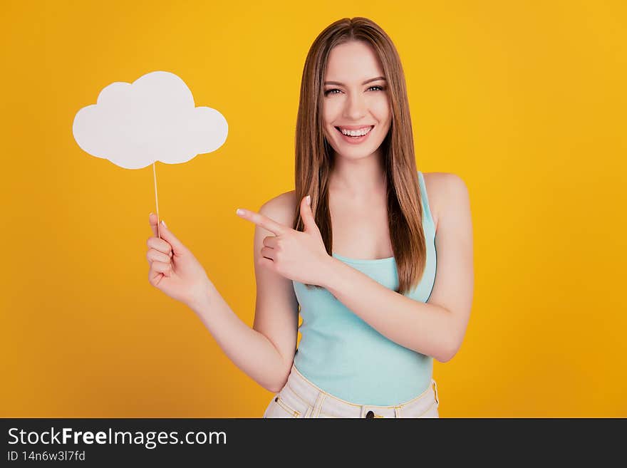 Portrait of positive promoter lady hold cloud stick indicate finger blank space on yellow background.