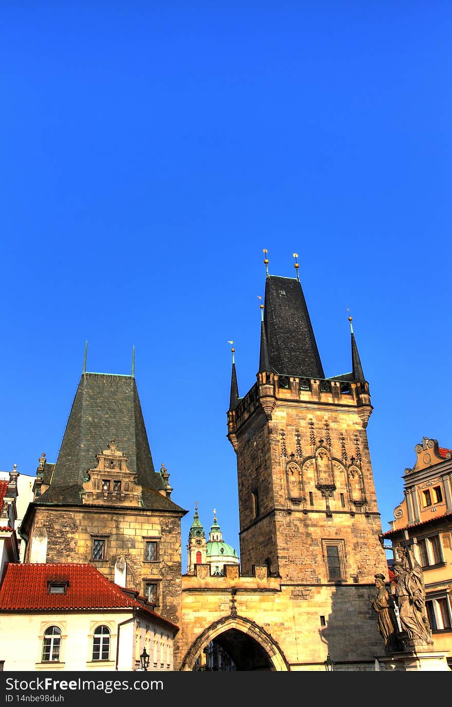 Malostranska district of Prague and the St Nicholas church, Prague towers lit by morning yellow sun. Malostranska district of Prague and the St Nicholas church, Prague towers lit by morning yellow sun