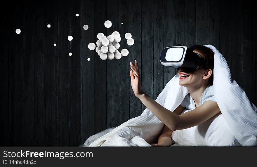 Woman with laptop submerged into virtual reality . Mixed media