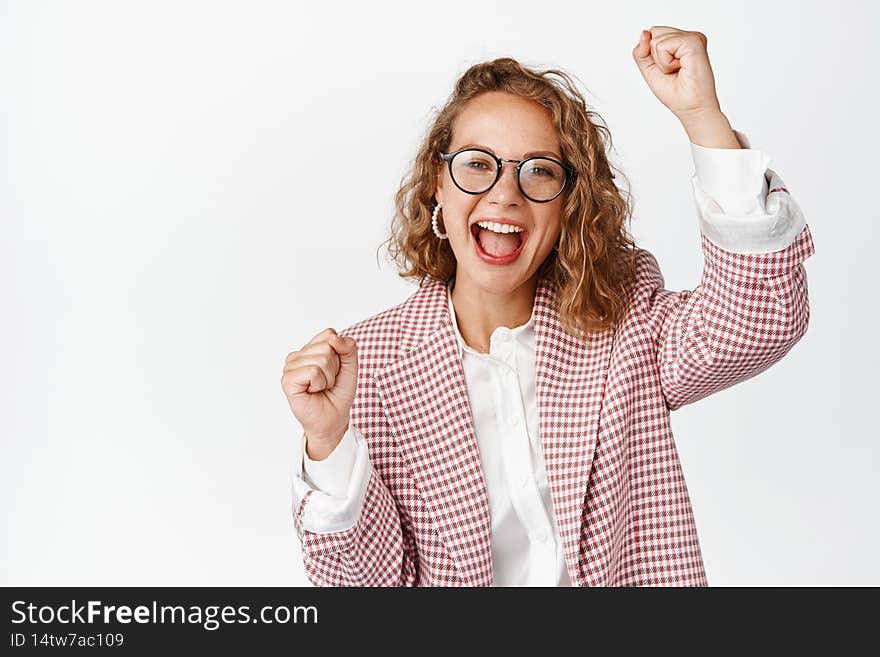 Cheerful blond business woman celebrating success, chanting and shouting, being an activist, rooting for company