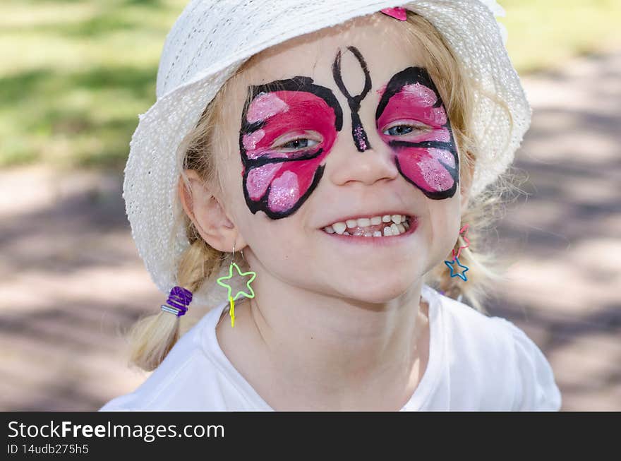 Blond girl with face painting. Blond girl with face painting
