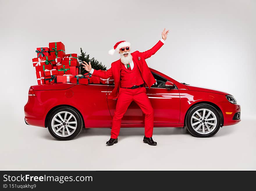 Full length body size view of attractive cheerful Santa dancing near car december season isolated over grey color background.