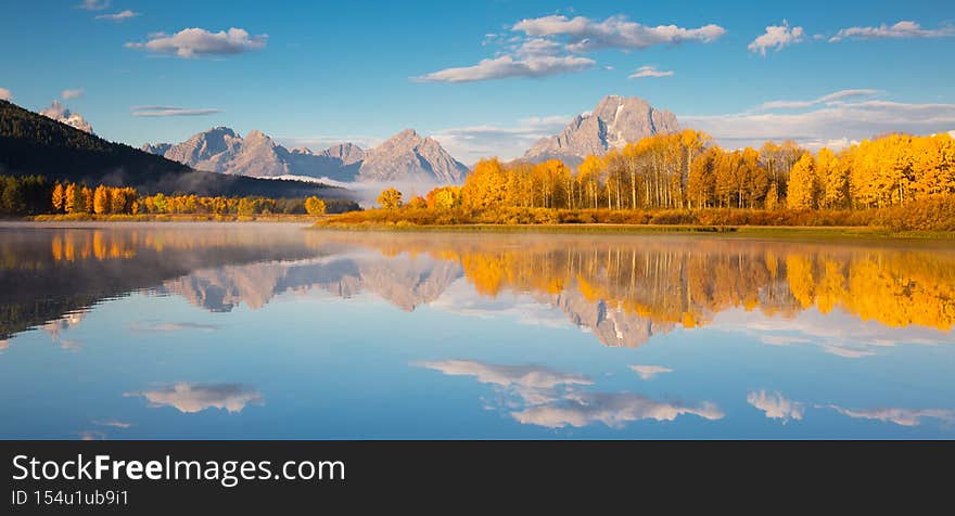 Panoramic autumn landscape with forest, stream and river in Grand Teton National Park. Fall nature background. Panoramic autumn landscape with forest, stream and river in Grand Teton National Park. Fall nature background