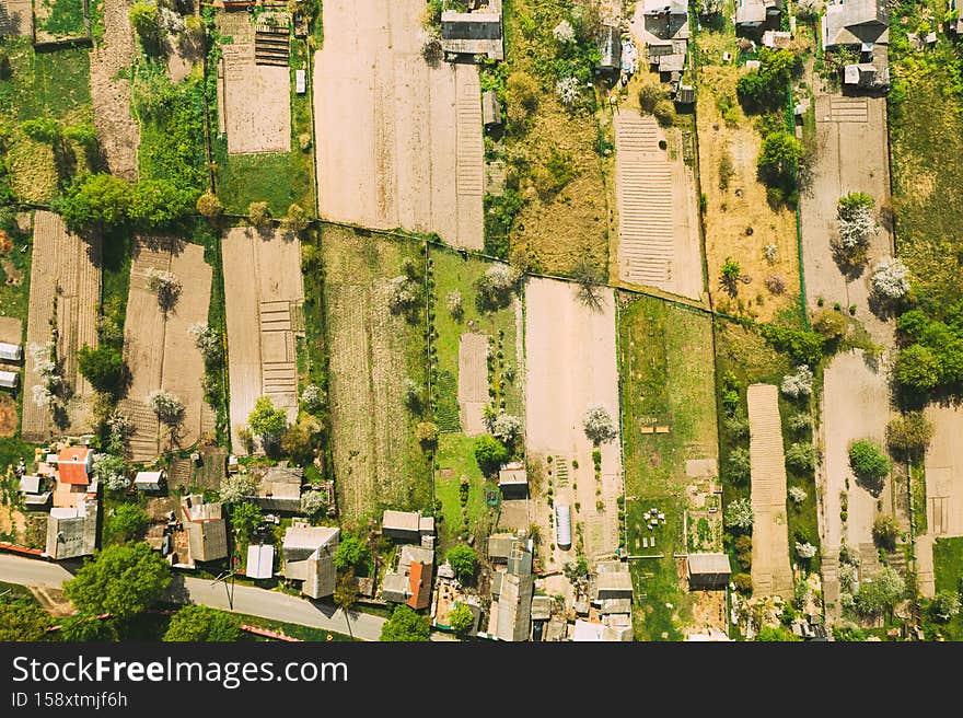 Russia. Aerial View Of Small Town, Village Cityscape Skyline In Summer Day. Residential District, Houses And Vegetable Garden Beds In Bird's-eye View.