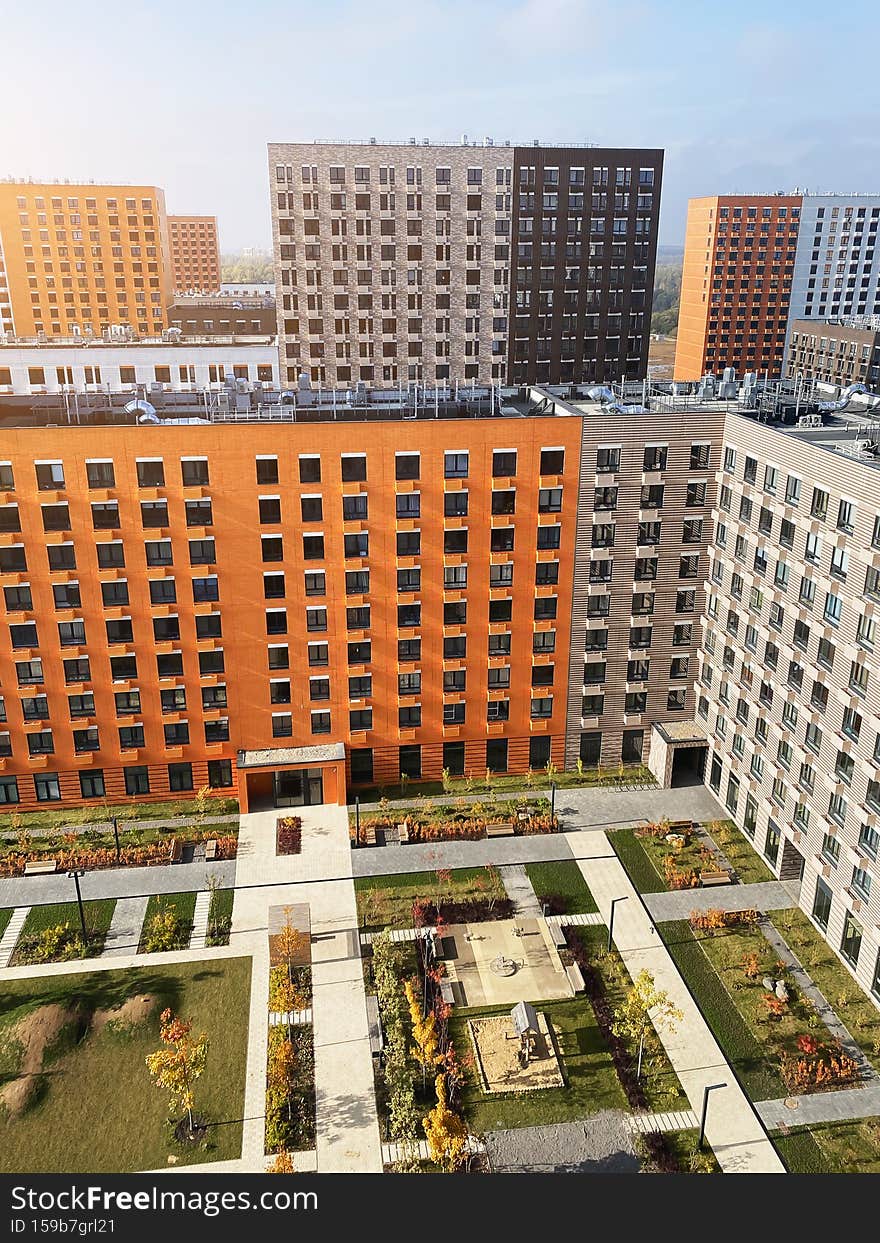 Facades of modern multi-apartment high-rise buildings, vertical photo