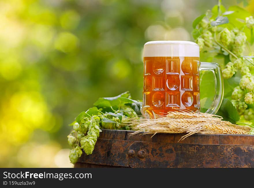 mug of beer with wheat ears and hop cones