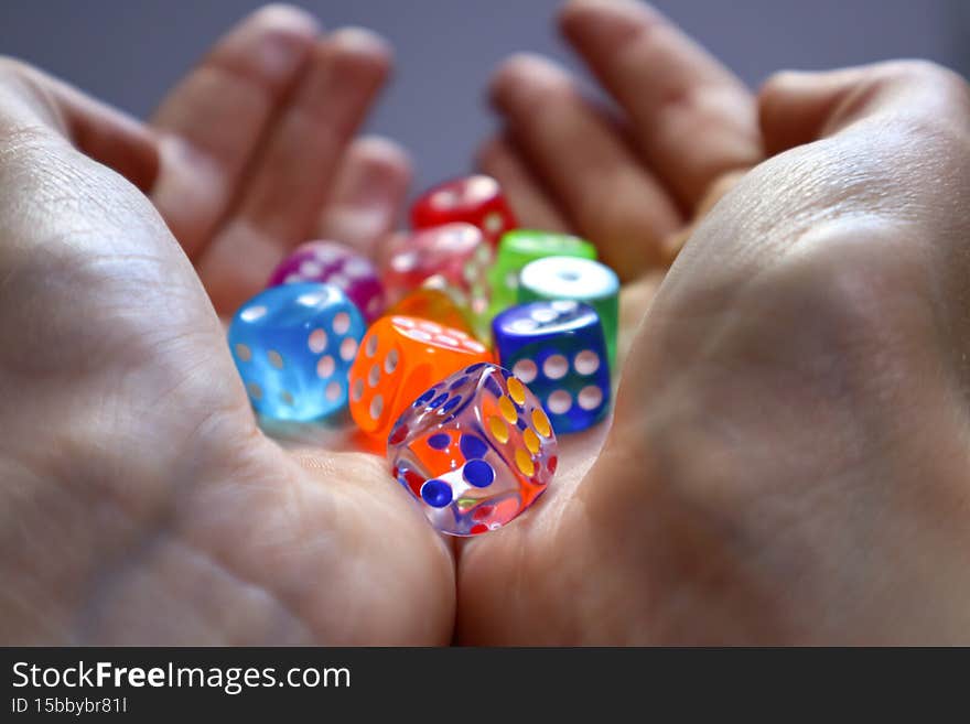 Transparent crystal cubes, bright dots color, exquisite and beautiful held in a woman's hand. Transparent crystal cubes, bright dots color, exquisite and beautiful held in a woman's hand