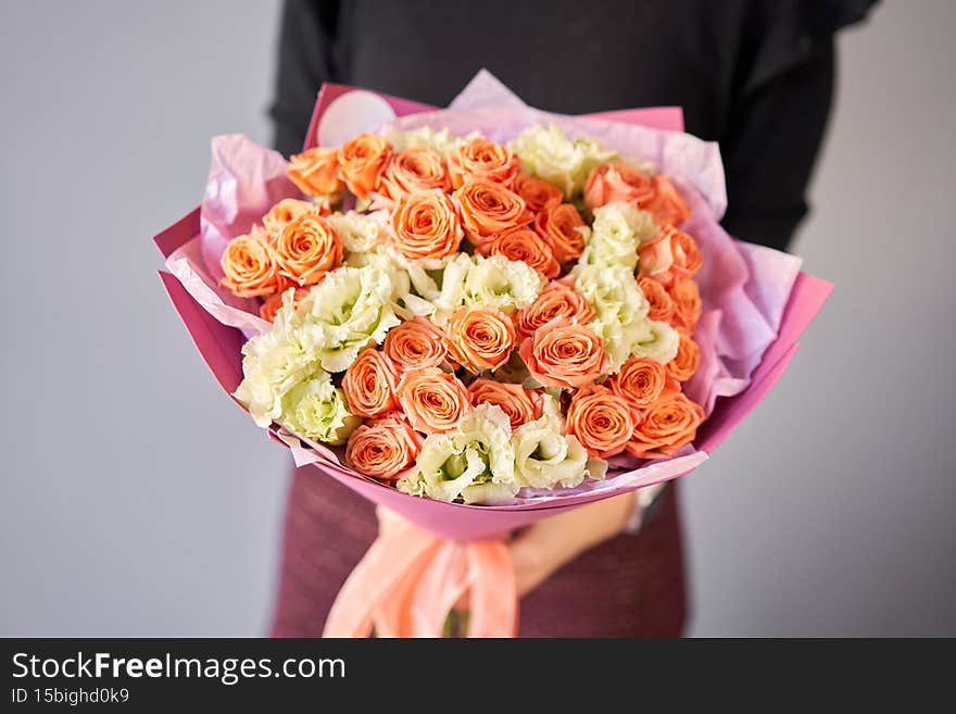 Large Beautiful bouquet of mixed flowers in woman hand. Floral shop concept . Beautiful fresh cut bouquet. Flowers delivery.