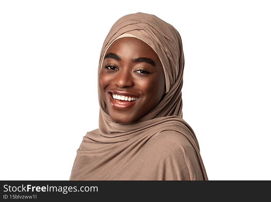 Portrait of happy black muslim lady in hijab laughing, looking and posing at camera, standing isolated over white studio background, empty space. African American lady in headscarf smiling. Portrait of happy black muslim lady in hijab laughing, looking and posing at camera, standing isolated over white studio background, empty space. African American lady in headscarf smiling