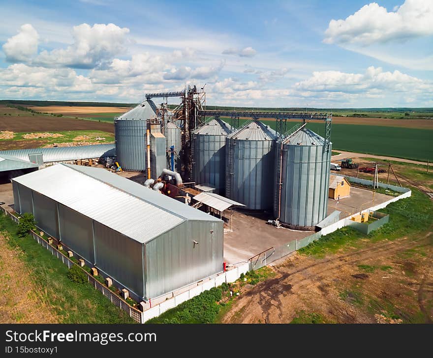 Aerial view. Grain elevator. Metal grain elevator in agricultural zone. Agriculture storage for harvest. Summer sunny day. Exterior of agricultural factory. Nobody. Ukraine.