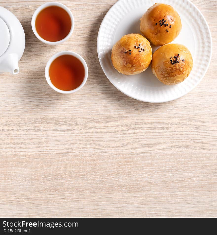 Top view design concept of Moon cake yolk pastry, mooncake for Mid-Autumn Festival holiday on wooden table background. Top view design concept of Moon cake yolk pastry, mooncake for Mid-Autumn Festival holiday on wooden table background
