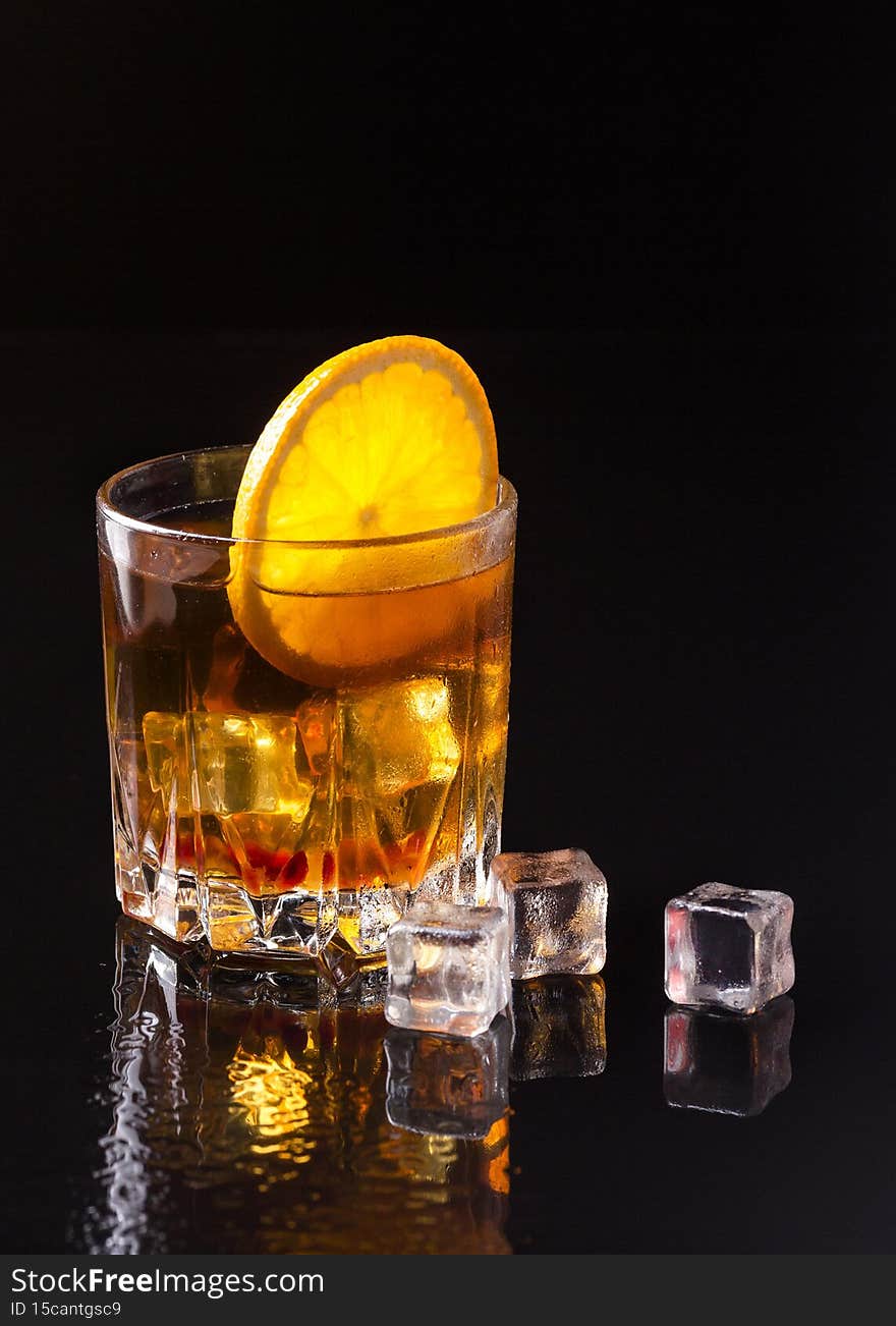 front view whiskey with orange ice. High quality photo