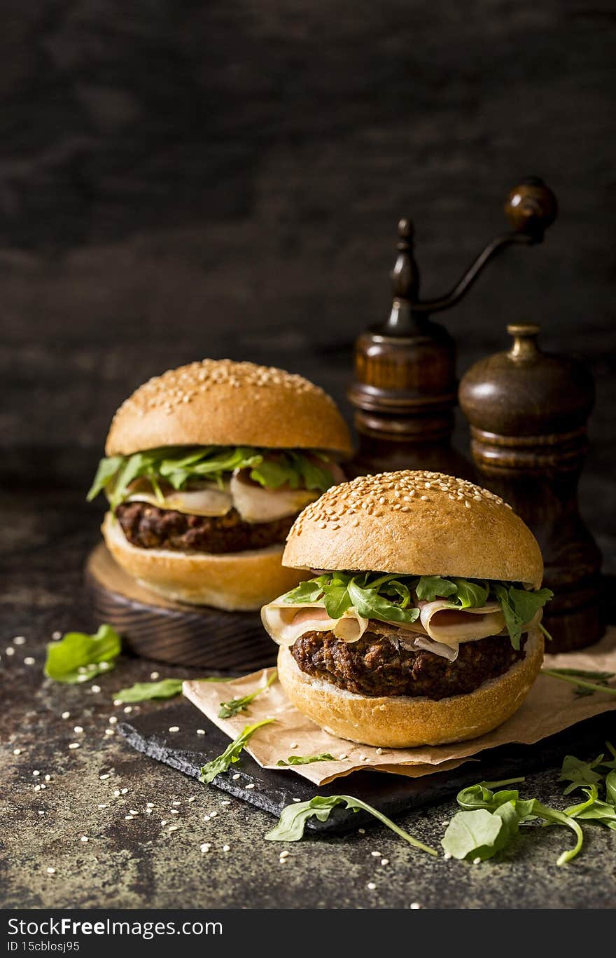 front view fresh beef burgers with bacon slate board 1. High quality photo