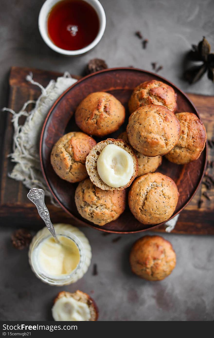 Lemon muffins with poppy seeds on a plate. Creamy half cupcake