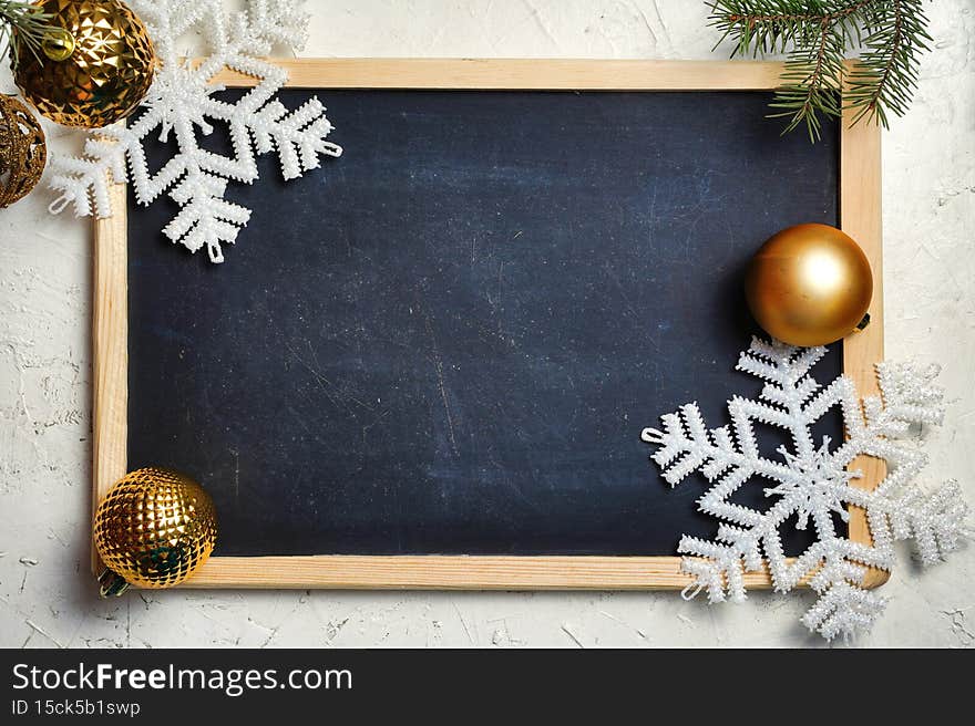 Christmas and New Year background. Christmas fir tree branches, gifts, pine cones on black board rustic background. Flat
